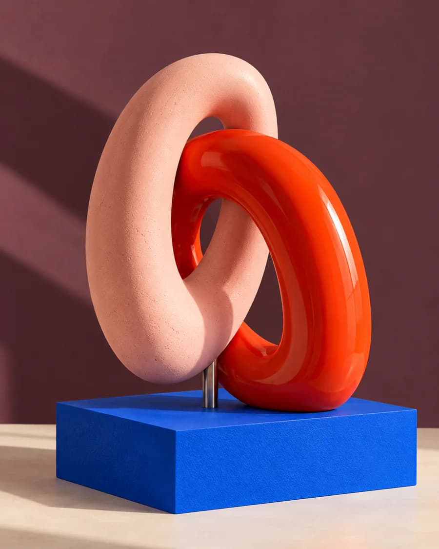 Deux anneaux entrelacés, rose et rouge, sur un socle bleu